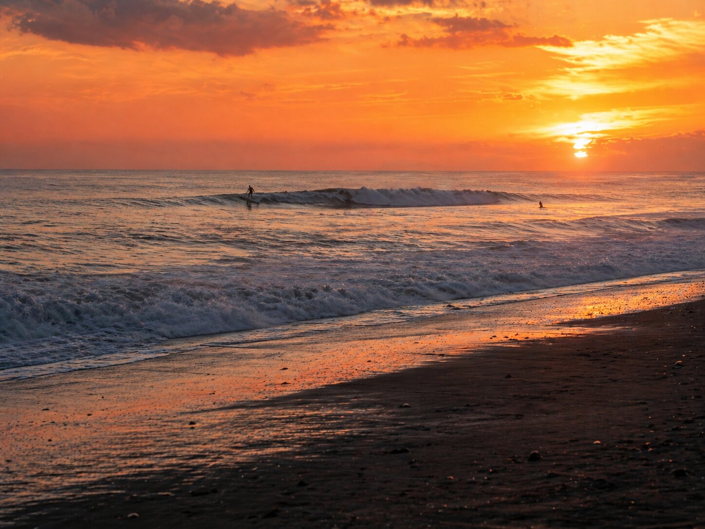 Surf break on Canggu beach at sunset